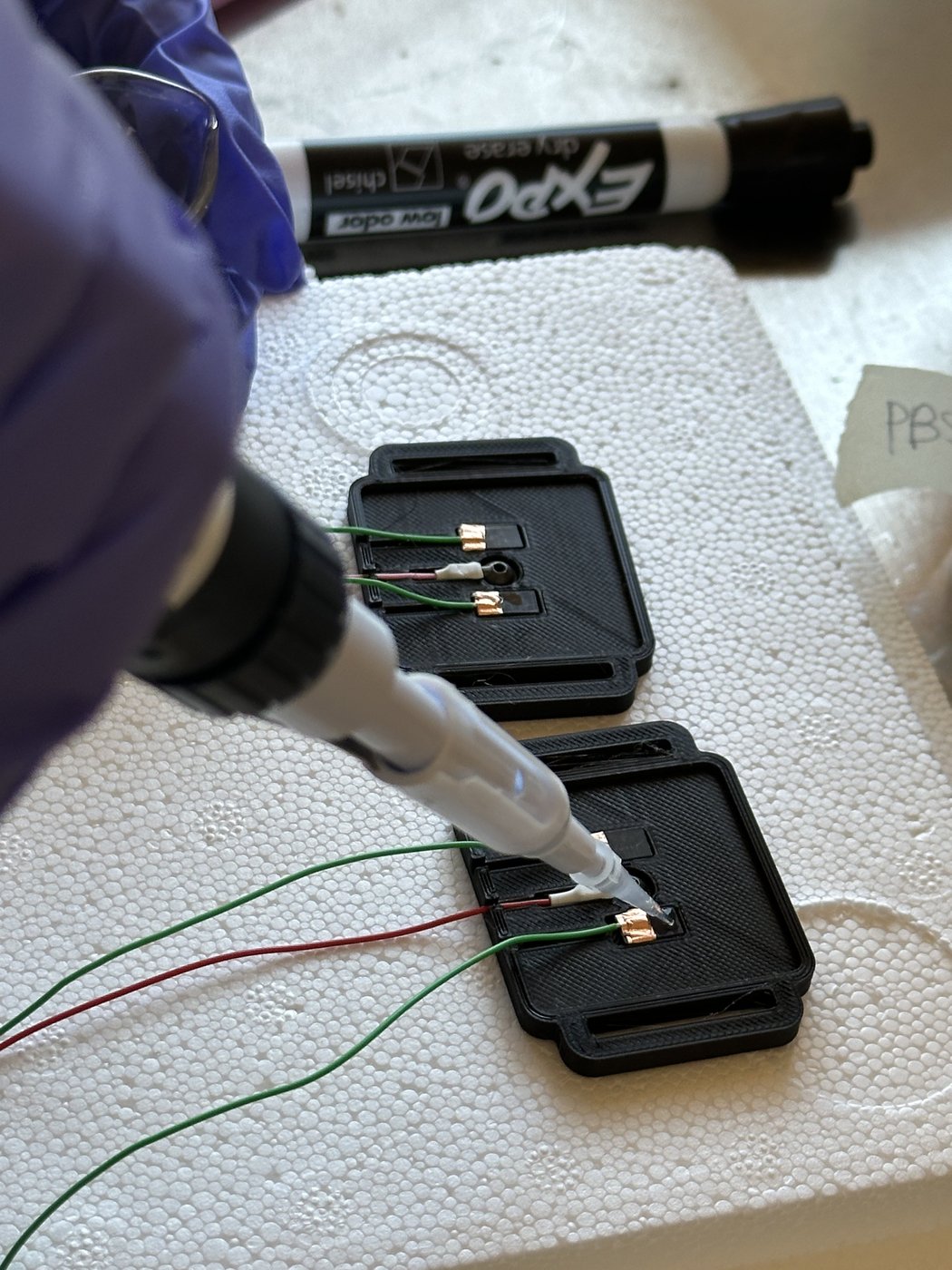 Casting the enzyme membrane by hand, drop by drop, onto a 3D-printed electrode housing.